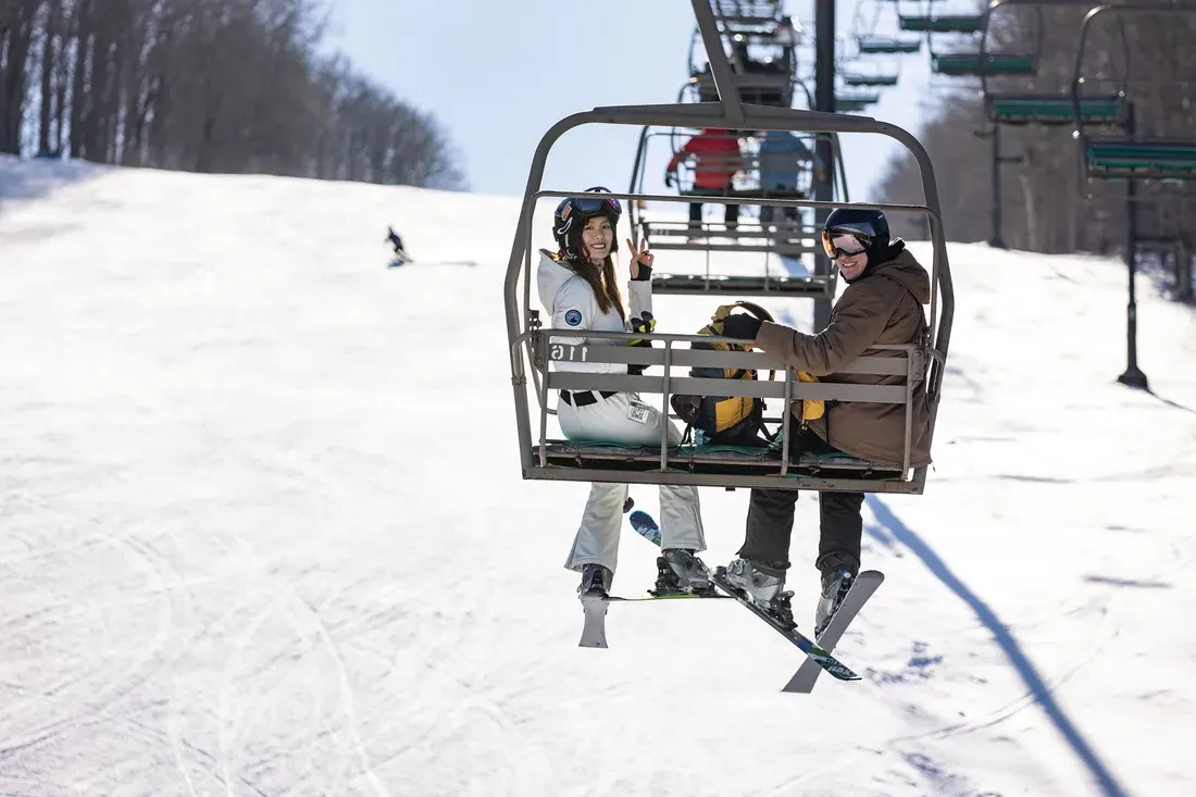 Two people on a chairlift at Song Mountain.